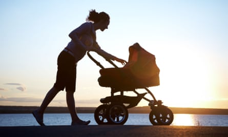 Silhouette of a mother with a child in a pram