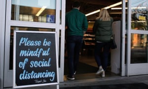 Shoppers enter a grocery store in Seattle, Washington.