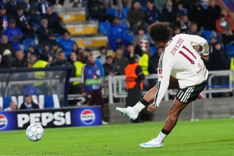 Joshua Zirkzee strikes the ball, scoring a goal for Manchester United in a match