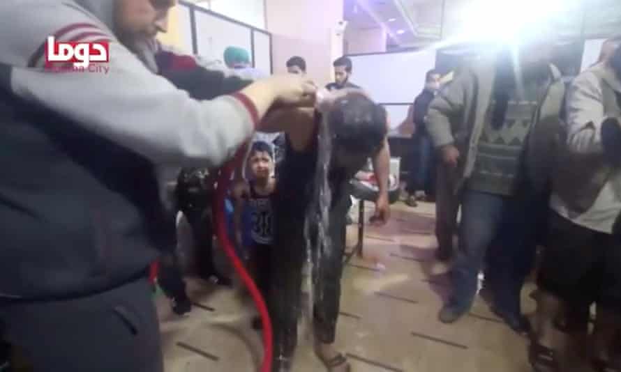 People are washed to try to remove nerve agents following a chemical weapons attack in Douma, Syria, on 7 April