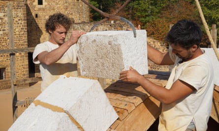 Workers moving blocks of stone at Guédelon