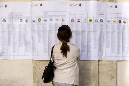 A woman studies candidate lists for the municipal elections.