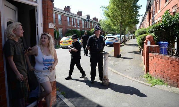Police officers stand on duty on Dorset Avenue in Moss following a raid on a residential property as investigations continue into the terror attack at the Manchester Arena. 