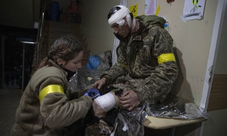 An injured Ukrainian soldier receives treatment at a military hospital after intense clashes with Russian forces in Bakhmut.