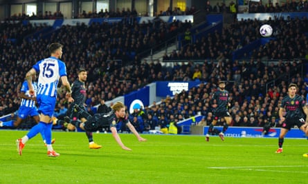 Kevin De Bruyne dives in to launch a header into the back of the net to give Manchester City the lead at Brighton.