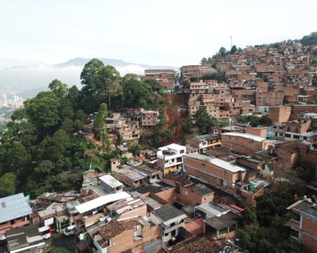 Densely packed brick houses on a hillside in Medellín.