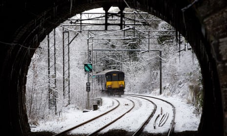 A Scotrail train leaves the station in the snow in Cambuslang, Glasgow
