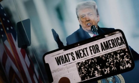 Phone screen with text 'what's next for America' in front of a photo of a white man speaking into microphone