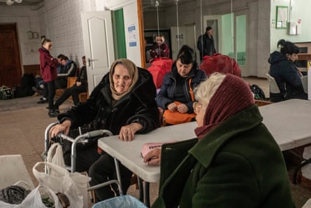 An elderly woman from Mariupol and other Ukrainians coming from the occupied territories wait at the Zaporizhzhia city council which has been turned into a centre for displaced people.