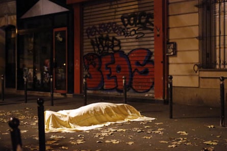 FILE - A victim of a terrorist attack lies dead outside the Bataclan theatre in Paris, Nov. 13, 2015. The Islamic State group claimed responsibility for Friday’s attacks on a stadium, a concert hall and Paris cafes that left more than 120 people dead and over 350 wounded. (AP Photo/Jerome Delay, File)