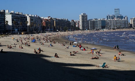 People seek relief near cool waters amid a heat wave in Montevideo, Uruguay.