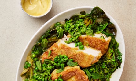 Crumbed chicken in a bowl with peas