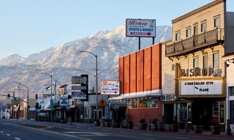 Town street in front of snowy mountains.