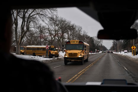Schools buses seen through a vehicle window
