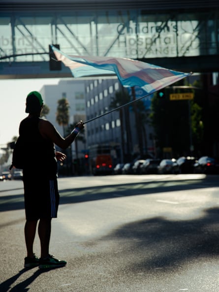 a person holding a flag outside of a building