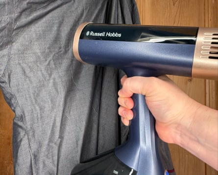 A Russell Hobbs steamer being used on a grey garment
