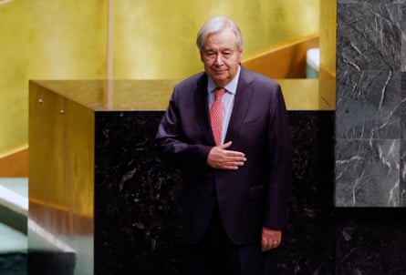 a man stands with his hand on his chest