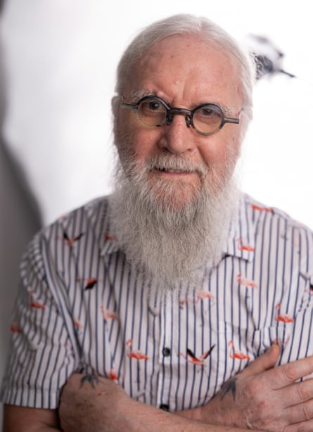 Portrait of Billy Connolly with hair tied back wearing a stripy shirt