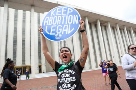 A person holds a sign that reads "keep abortion legal"