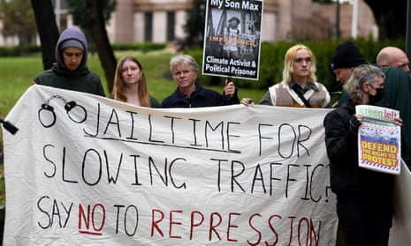 Protesters hold banner saying no to jail time for slowing traffic