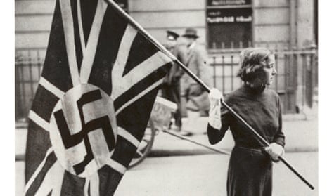 Female supporter of the British Union of Fascists carrying a flag in London in the 1930s.