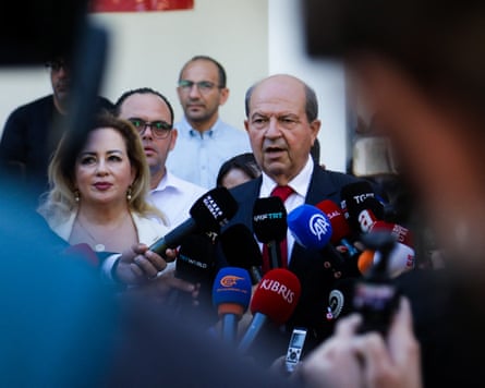 Turkish Cypriot leader Ersin Tatar stands in front of several microphones as he speaks to the media.