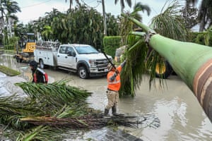 Workers from the city of Naples, Florida, clean up debris