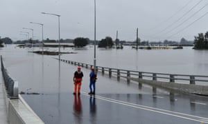 Flooding in New South Wales<br>epa09090731 SES flood rescue team members inspect floodwaters flowing over the New Windsor Bridge at Windsor in north western Sydney, Australia, 23 March 2021. Thousands of residents are fleeing their homes, schools are shut, and scores of people have been rescued as NSW is hit by once-in-a-generation flooding.  EPA/DEAN LEWINS AUSTRALIA AND NEW ZEALAND OUT
