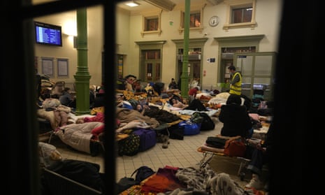 Women and children, fleeing from Ukraine, sleep at a makeshift shelter in the train station in Przemysl, Poland, Thursday, March 3, 2022.