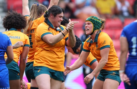 Australia's Emily Chancellor (right) and teammates celebrate after Katalina Amosa scores their first try.