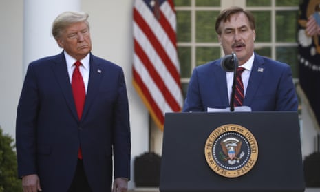 Mike Lindell speaks as Donald Trump listens during a coronavirus briefing at the White House on 30 March 2020. 