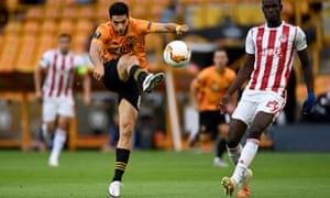 Raul Jimenez of Wolves shoots under pressure from Ousseynou Ba of Olympiacos.