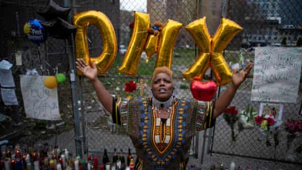 A woman at a memorial for musician and actor DMX outside White Plains Hospital in New York.