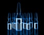 Different medical ampules toned blue on black background.