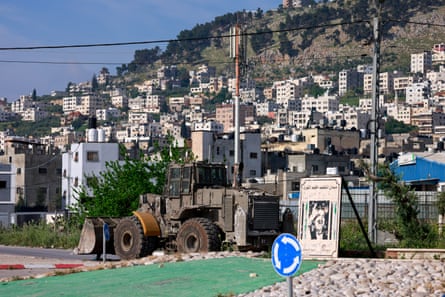 An Israeli military bulldozer patrols the Balata refugee camp in the northern West Bank on Monday, following a raid on the camp.