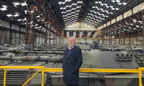 Freddy Versluys standing in front of German-made Leopard 1 tanks.