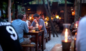 Guests dine by candlelight.