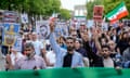 Protesters hold signs with photographs of the Iranian rapper and banners reading: 'Stop executions in Iran'