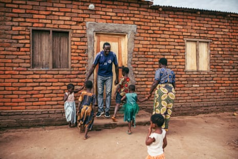 Gladys Austin and her family in front of their new brick house