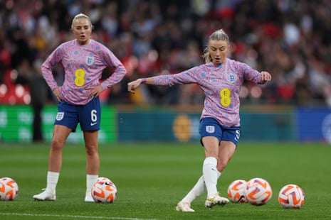 England's Leah Williamson kicks the ball watched by Alex Greenwood as she warms-up before the Women's Finalissima soccer match between England and Brazil at Wembley.