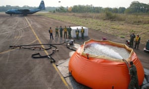A Brazilian air force Hercules C-130 waiting to collect bags of water to fight fires in the Amazon rainforest on Saturday
