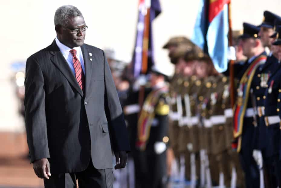 Manasseh Sogavare, prime minister of the Solomon Islands, inspects a guard of honour during a ceremonial welcome at Parliament House in Canberra. He and Malcolm Turnbull signed a security deal.