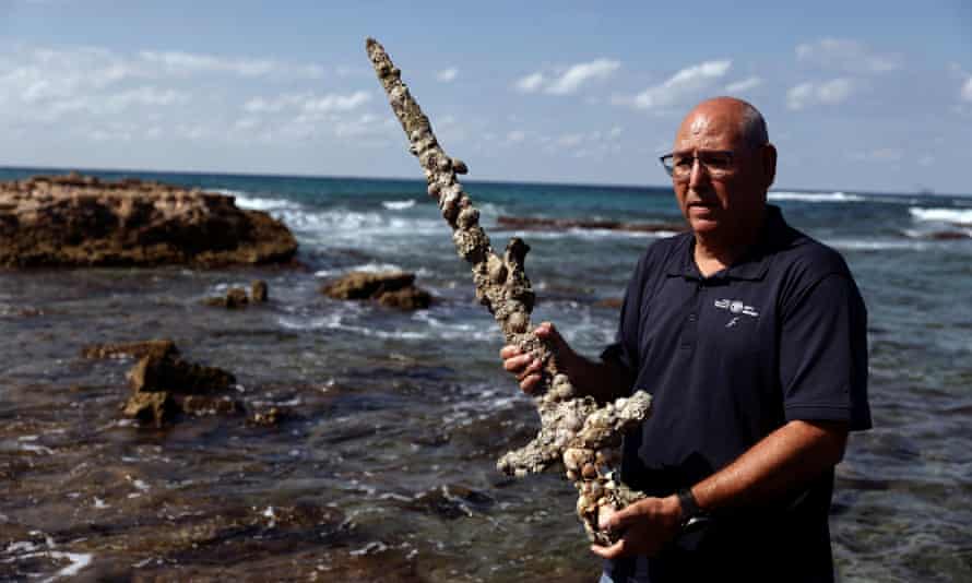 Koby Sharvit of the IAA holds a sword believed to have belonged to a crusader who sailed to the Holy Land almost a millennium ago.