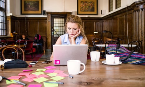 freelancer using laptop at cafe table