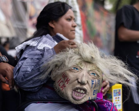 A protest against Fifa in Mexico City on 6 June in which a woman holds a dummy head of Donald Trump