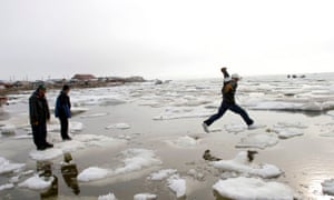 Teenagers go ice-hoping on the Chukchi Sea in Shishmaref, Alaska, US.