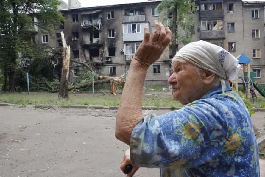A woman gestures near an apartment building damaged during shelling in Donetsk, in territory controlled by the self-proclaimed Donetsk People’s Republic.