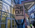 person holds sign saying 'ice out'