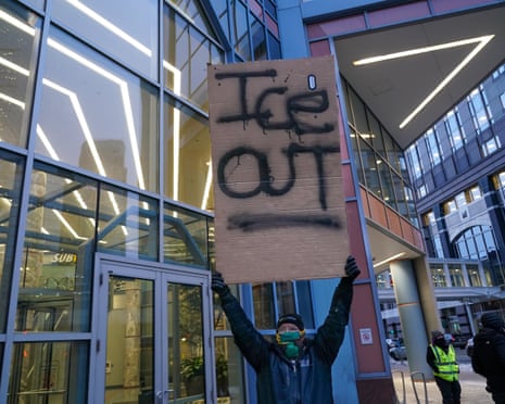 person holds sign saying 'ice out'