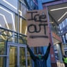 person holds sign saying 'ice out'